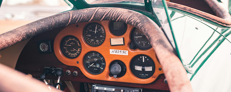 An image of a vintage plane cockpit with leather details and orange dial surround, alluding to a study done on inclusive design.