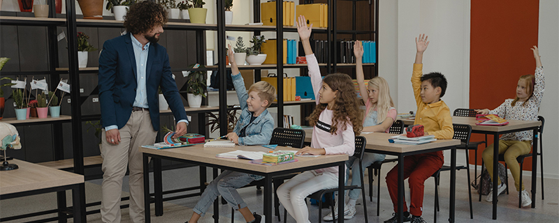 Adaptive teaching in action as a teacher engages with pupils in a classroom.